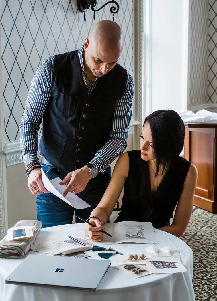 A professionally dressed couple doing paperwork together